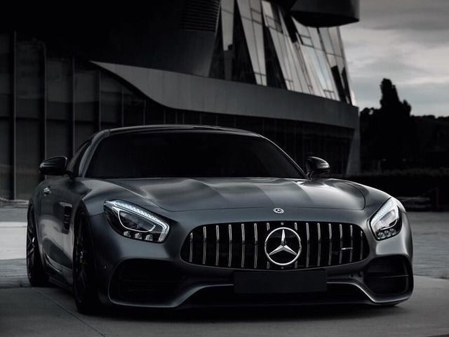 Black Mercedes-Benz sports car with signature grille and logo displayed on a laptop screen in a website editor.